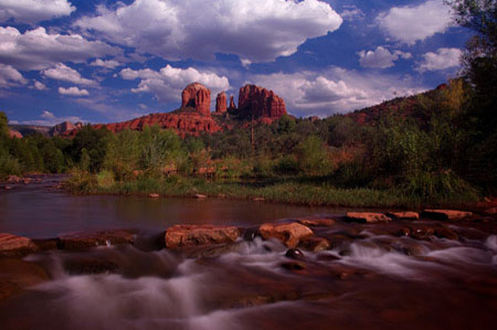 Puffy clouds dot the sky behind Cathedral Rock in Sedona